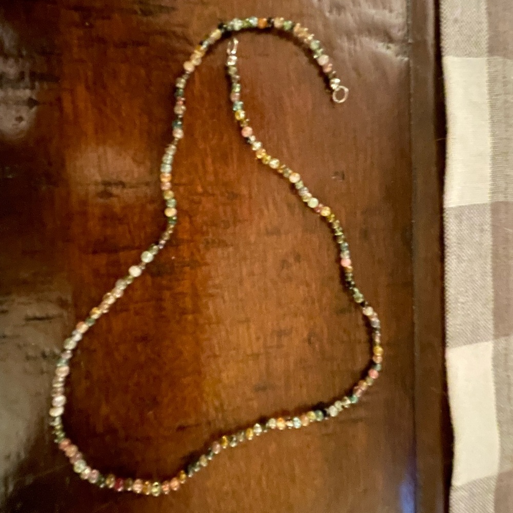 Tourmaline bead strand with silver rings at the end.